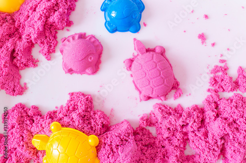 Pink magic sand shaped turtle and fish on a white background. Early sensory education. Preparing for School. Development