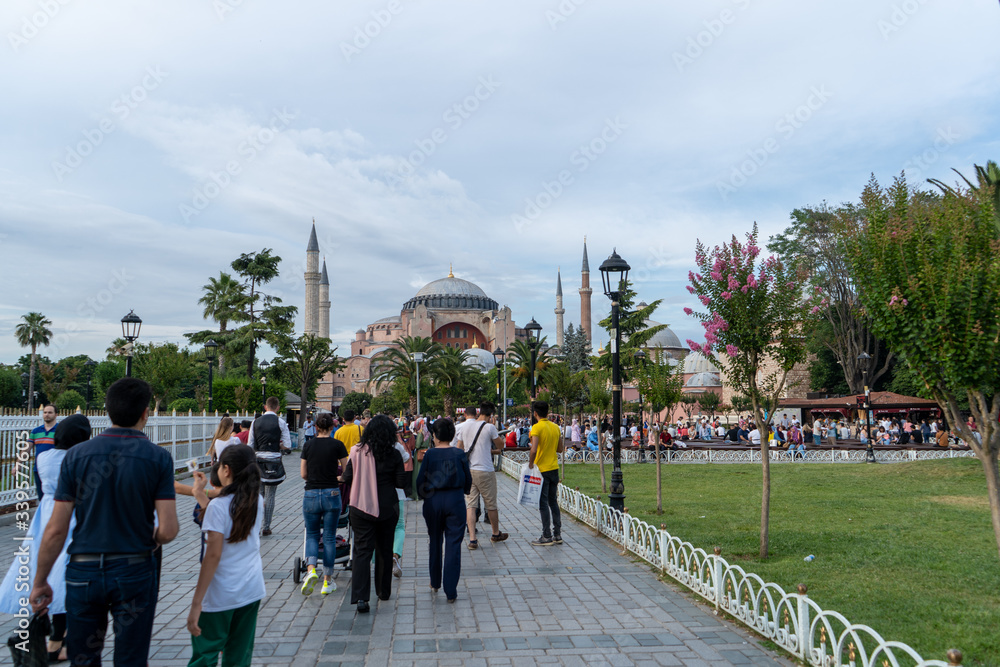 Fototapeta premium Park near Hagia Sophia and a lot of locals who are walking around in the evening. July 2019