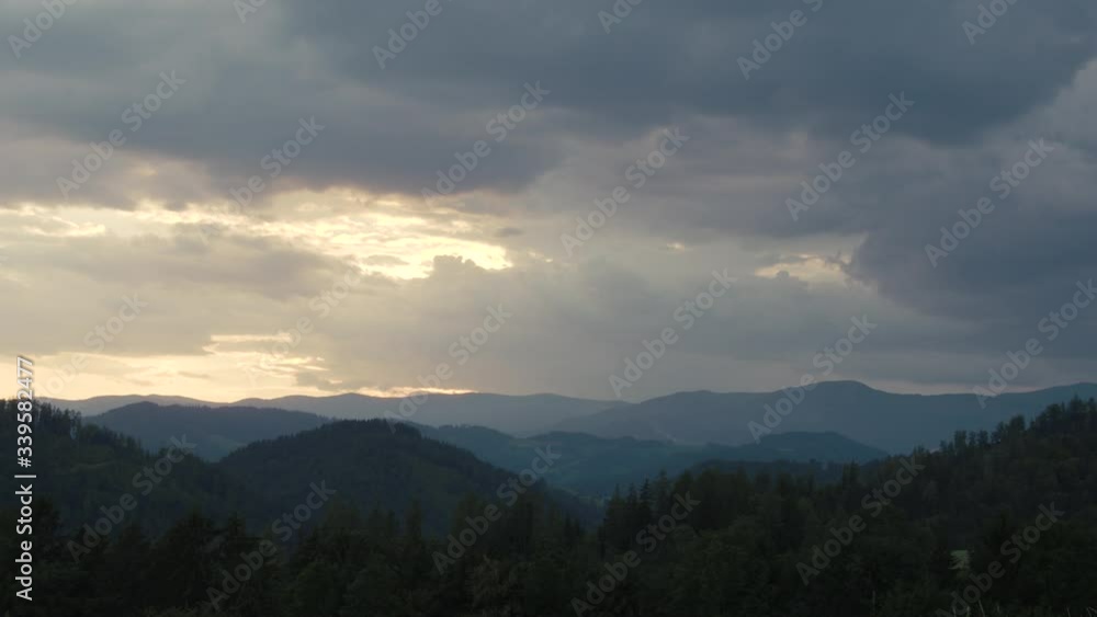 Ascending rain clouds darken the sky in the mountains Ascending rain clouds darken the sky in the mountains
