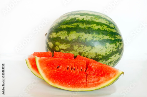 Ripe watermelon. Pieces of red watermelon. White background.