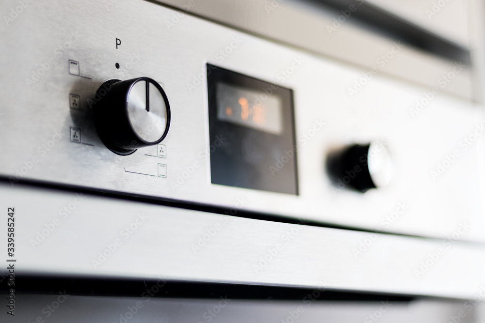 digital screen and grey and black oven button with temperature icon digital screen and grey and black oven button with temperature icon