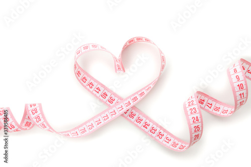 Measuring tape in the form of heart isolated on white background