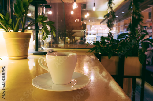 closeup of a cup of coffee at coffee shop or cafe interior