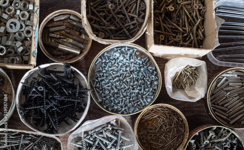 Various hardware, nails, screws and bolts in boxes. Home workshop