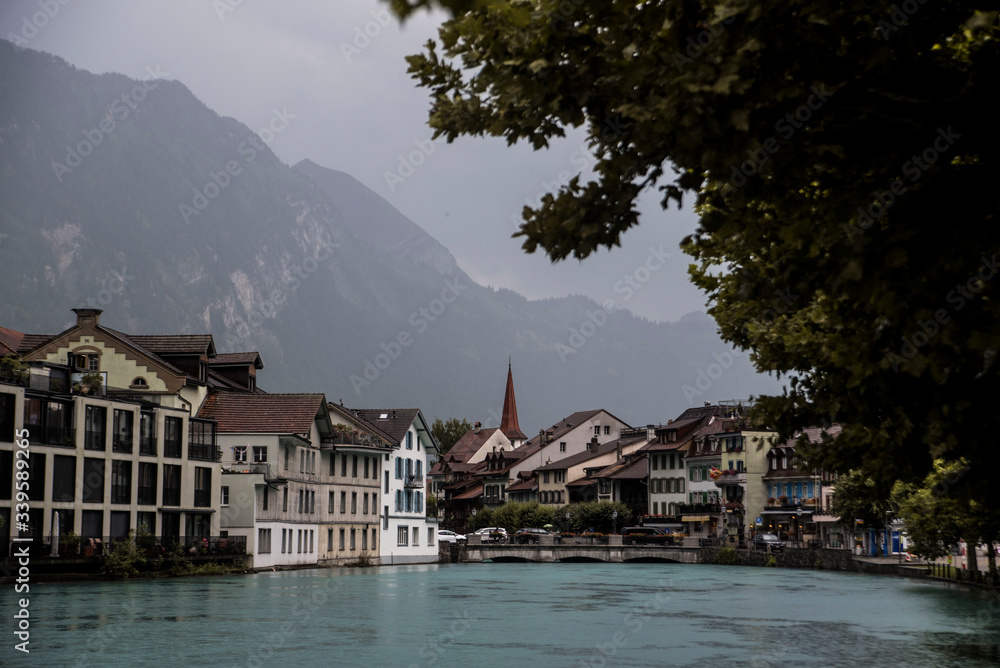 river leading to quaint swiss village in the alps