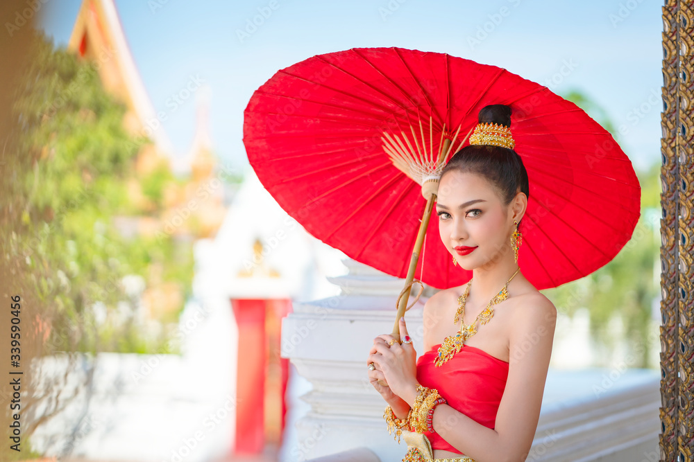 Luxury portrait of a beautiful Thai girl in traditional thai red ...