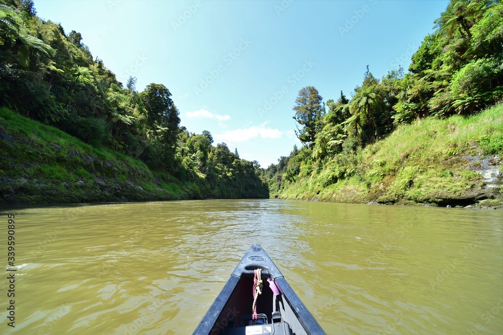 Fototapeta premium Canoe on the Tongariro River in the Tongariro National Park on the side of the jungle