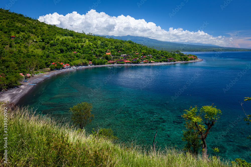 Green and hilly coastline of Bali island in the area of Amed village, Indonesia