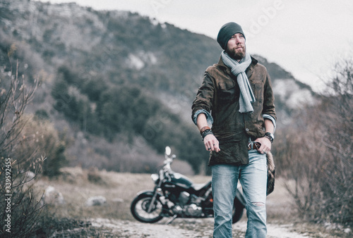 Young beard man on a bike in mountances