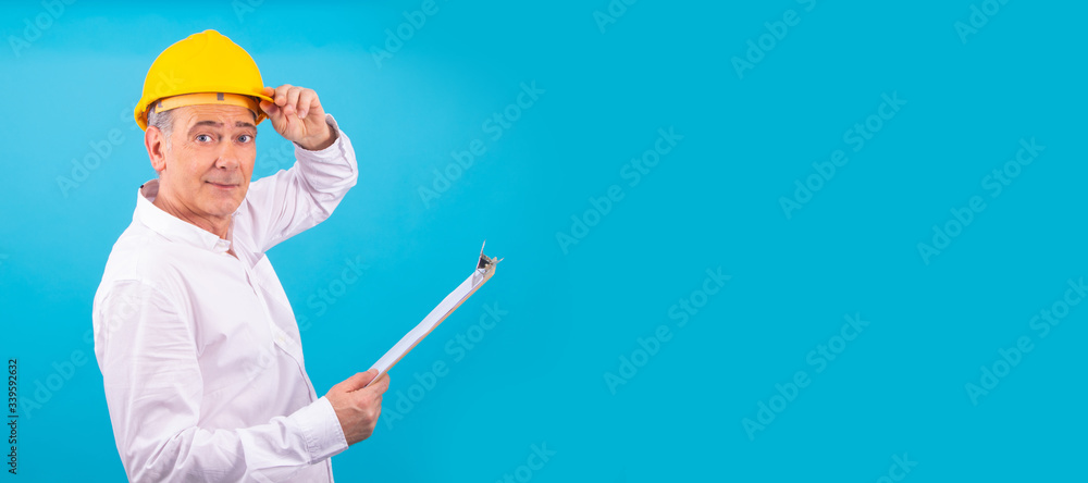 man isolated on color background with construction helmet man isolated on color background with construction helmet