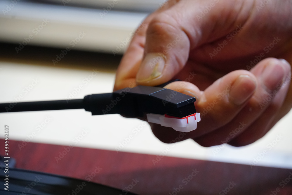 Turntable spindle. Male fingers holding a record player needle Turntable spindle. Male fingers holding a record player needle