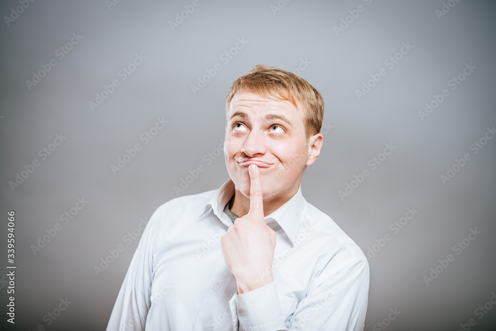 Puzzled handsome young man scratching his head with his hand as he looks at the camera with an uncertain perturbed expression, isolated on white Puzzled handsome young man scratching his head with his hand as he looks at the camera with an uncertain perturbed expression, isolated on white