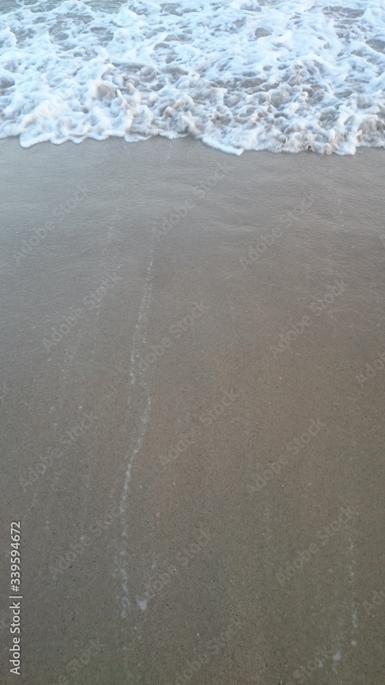 Sea wave over sand