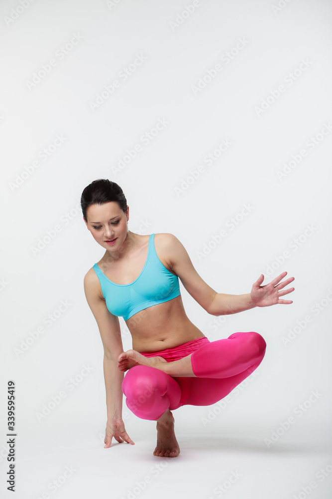 Obraz premium Young beautiful yoga instructor is posing in studio.