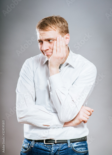 portrait of mature business man with hand on chin, looking at camera. head and shoulders, front view, copy space