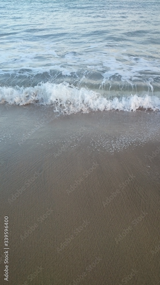 Wave of the sea on the sand beach