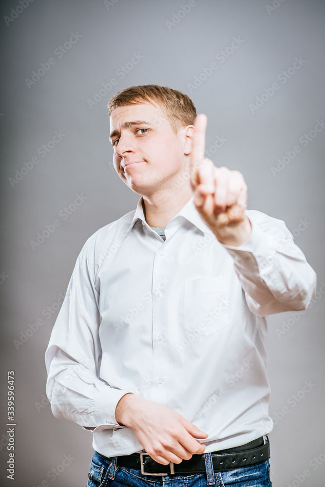a young and handsome businessman pointing up with his finger a young and handsome businessman pointing up with his finger