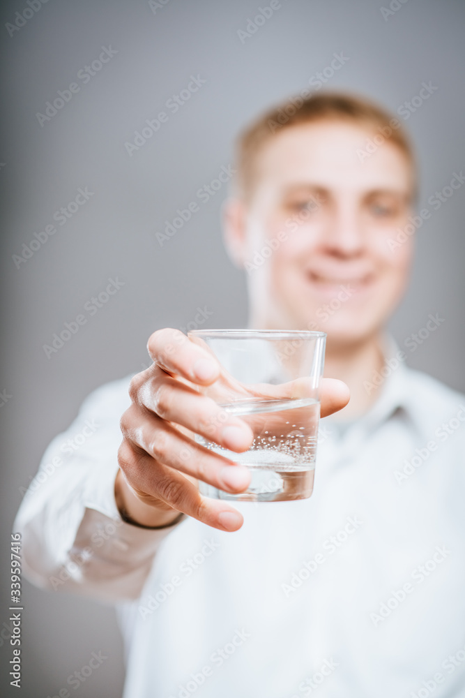 handsome man in white shirt with glass of water handsome man in white shirt with glass of water