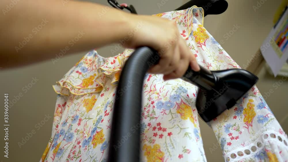 Closeup of a woman ironing clothing by stream iron on board at home with slow motion scene. 4K 25fps Closeup of a woman ironing clothing by stream iron on board at home with slow motion scene. 4K 25fps
