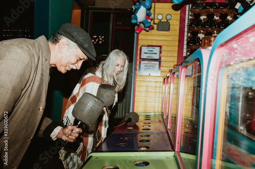 Smiling couple enjoying whack a mole