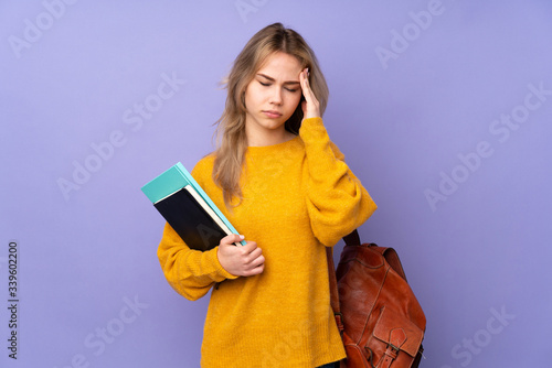 Teenager Russian student girl isolated on purple background with headache