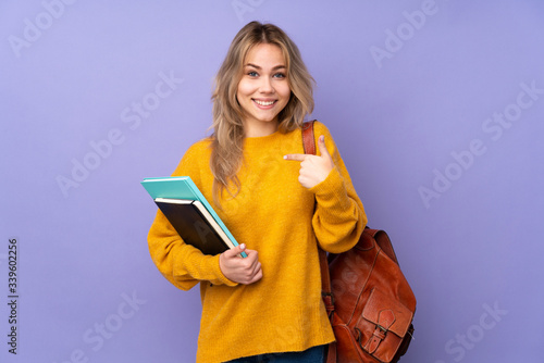 Fototapeta Teenager Russian student girl isolated on purple background with surprise facial