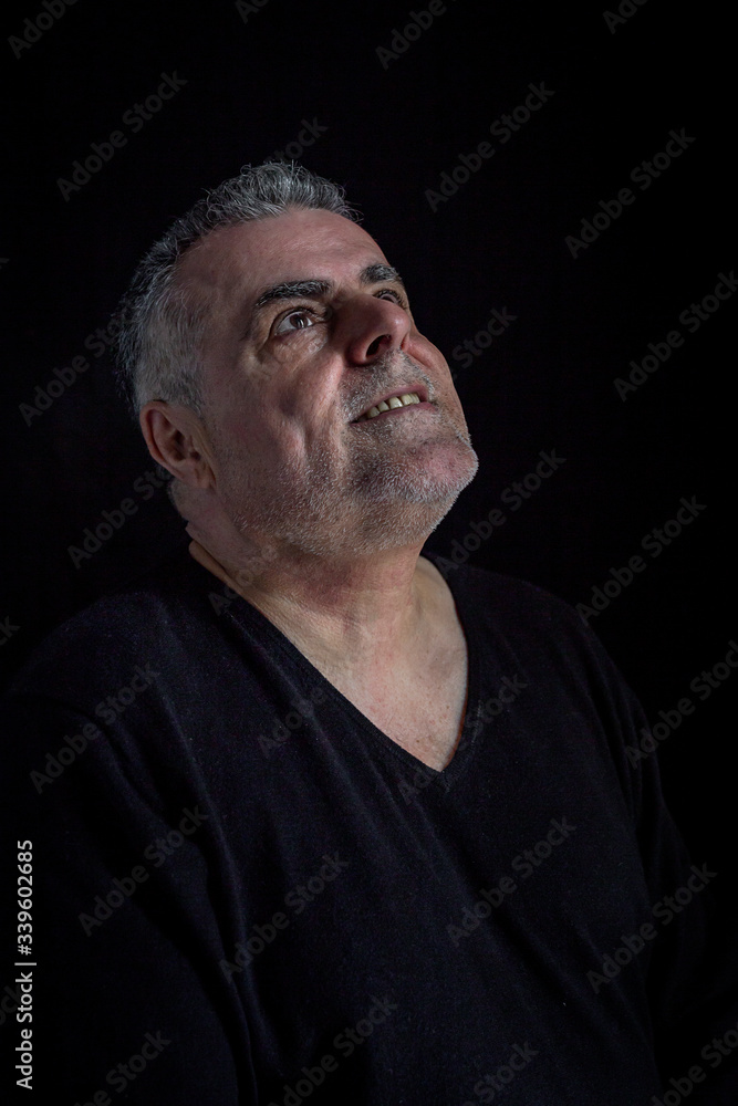 Portrait of mature man with beard on dark background Portrait of mature man with beard on dark background