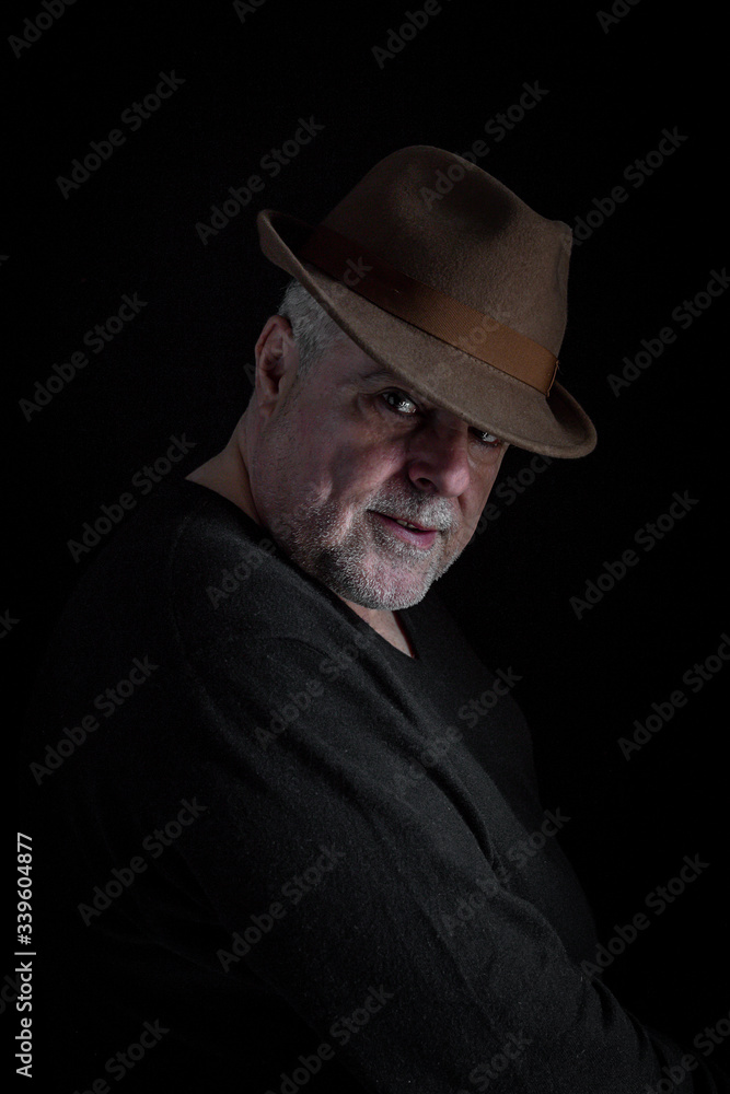 Portrait of mature man with beard on dark background Portrait of mature man with beard on dark background