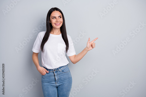 Look coronavirus new antidote advertisement. Positive confident girl point index finger copyspace demonstrate medical promotion wear trendy clothes isolated over gray color background