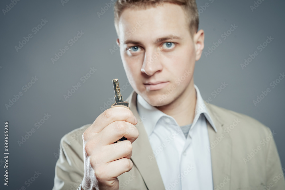 Cheerful corporate man holding key Cheerful corporate man holding key