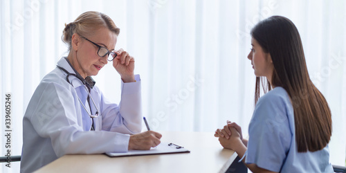 Female doctor and a patient woman discussion at clinic