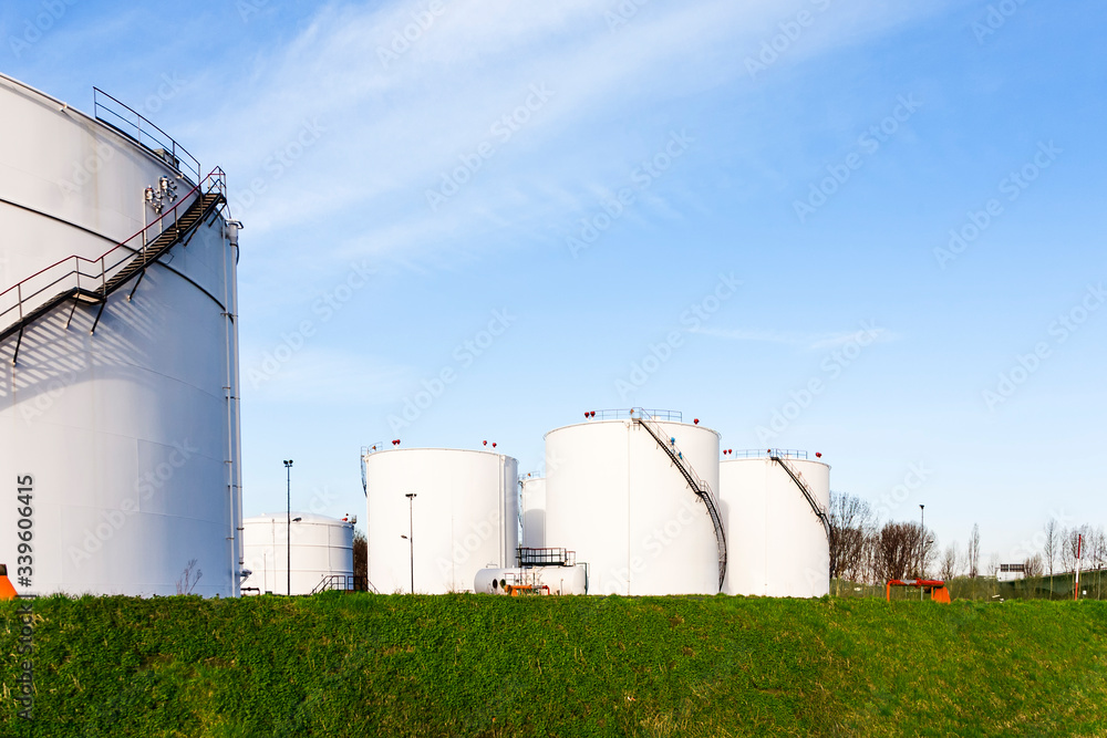 white industry petrol tanks in a tank farm as generic symbol for Industry white industry petrol tanks in a tank farm as generic symbol for Industry
