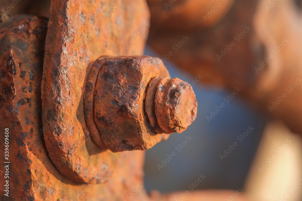 Orange rusty old bolts and nut made from steel close-up. Orange rusty old bolts and nut made from steel close-up.