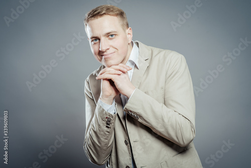 Young handsome man in  suit  looking at camera thinking or dreaming