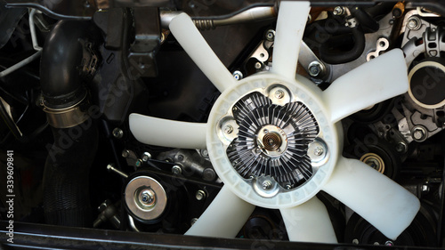 Fotografi Modern system of cooling with a large fan blades from the car engine closeup,  c