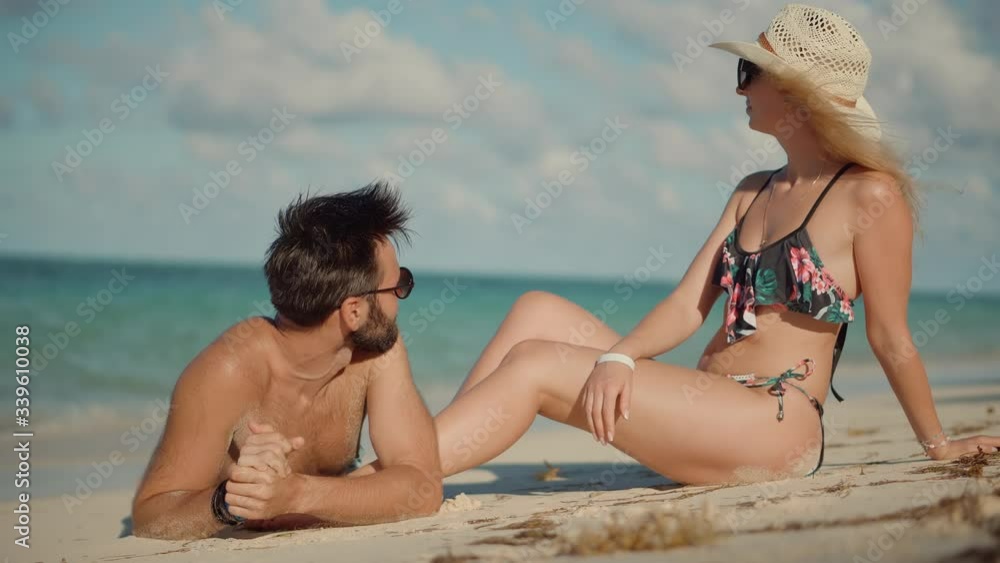 Beautiful Couple Sitting Together On Tropical Beach.Happy Romantic Couple Enjoying Relaxing Ocean On Caribbean Resort.Honeymoon Holidays On Maldives Or Bahamas.Attractive Lovers Vacation Travel At Sea Beautiful Couple Sitting Together On Tropical Beach.Happy Romantic Couple Enjoying Relaxing Ocean On Caribbean Resort.Honeymoon Holidays On Maldives Or Bahamas.Attractive Lovers Vacation Travel At Sea