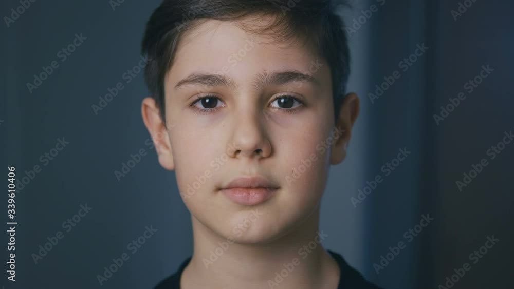 Portrait of cute boy of 11 ages looking at camera at home in the evening Portrait of cute boy of 11 ages looking at camera at home in the evening