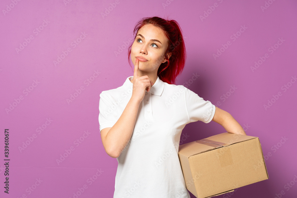 Teenager delivery girl isolated on purple background having doubts while looking up Teenager delivery girl isolated on purple background having doubts while looking up