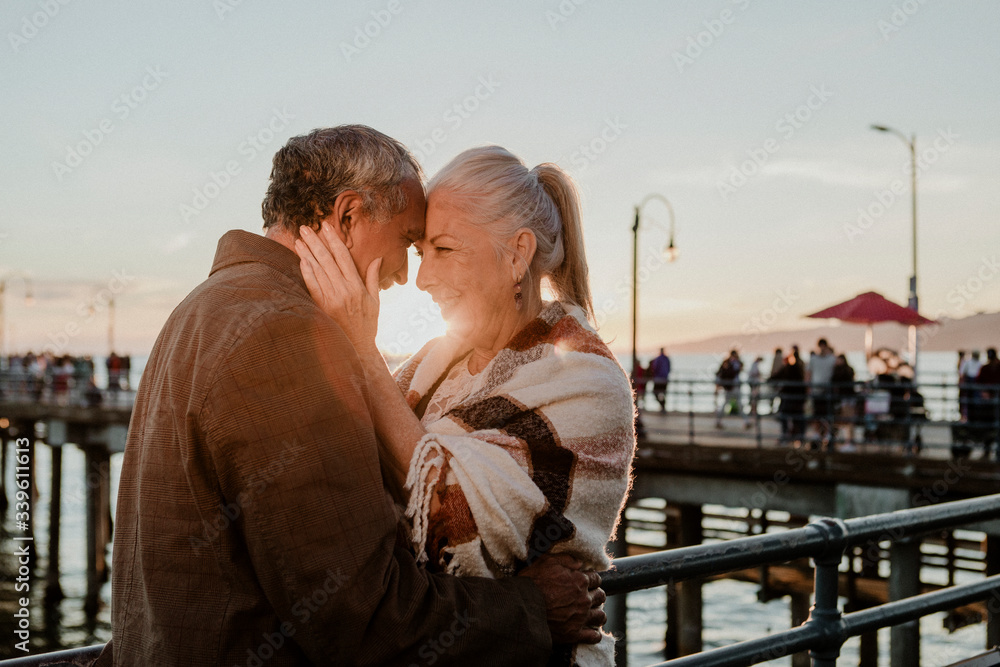 Senior couple intimately embracing by the sea