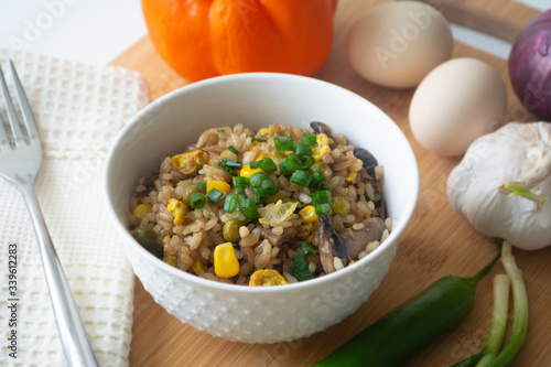 Chinese style vegetarian egg fried rice with sweet corn, green peas, onions, garlic, mushrooms and scallions