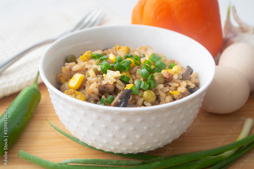 Chinese style vegetarian egg fried rice with sweet corn, green peas, onions, garlic, mushrooms and scallions Chinese style vegetarian egg fried rice with sweet corn, green peas, onions, garlic, mushrooms and scallions