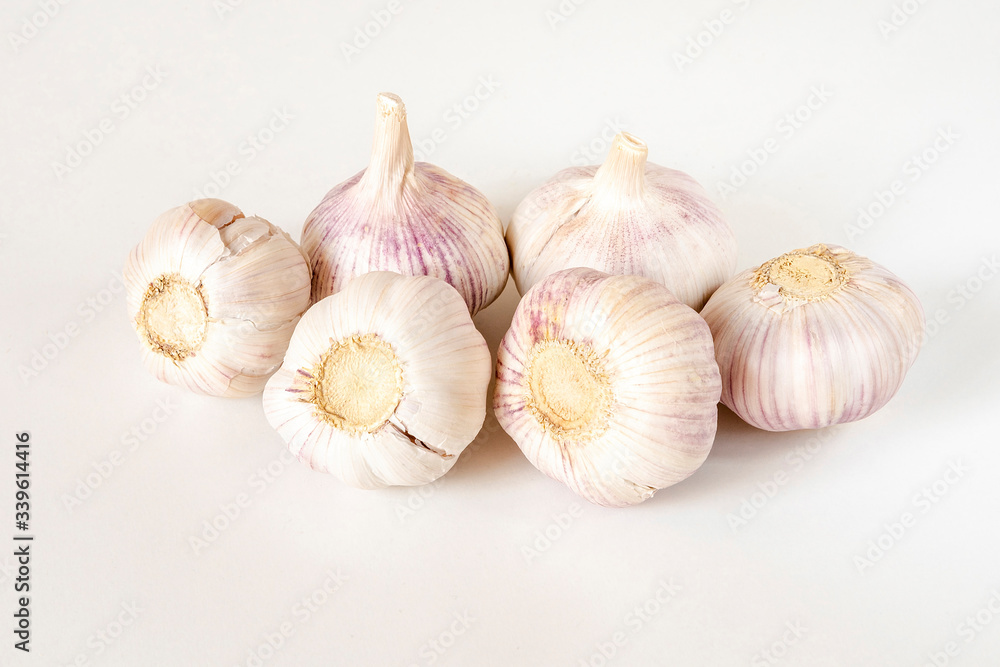 Garlic bulbs and garlic cloves on a white background. Garlic bulbs and garlic cloves on a white background.