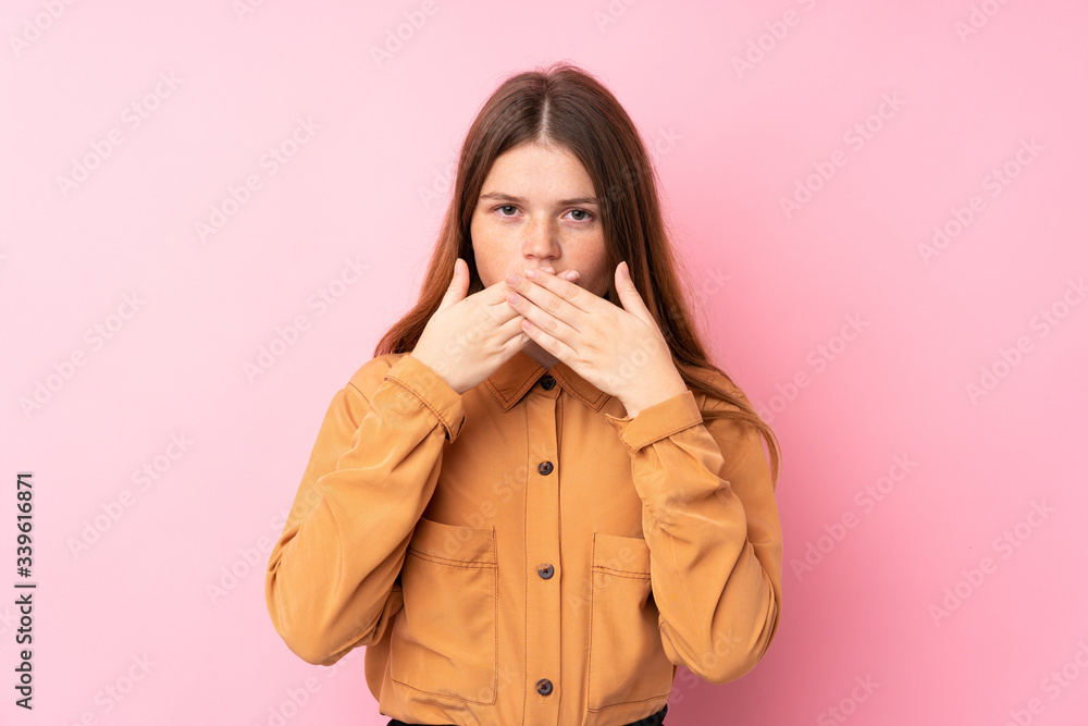 Ukrainian teenager girl over isolated pink background covering mouth with hands Ukrainian teenager girl over isolated pink background covering mouth with hands