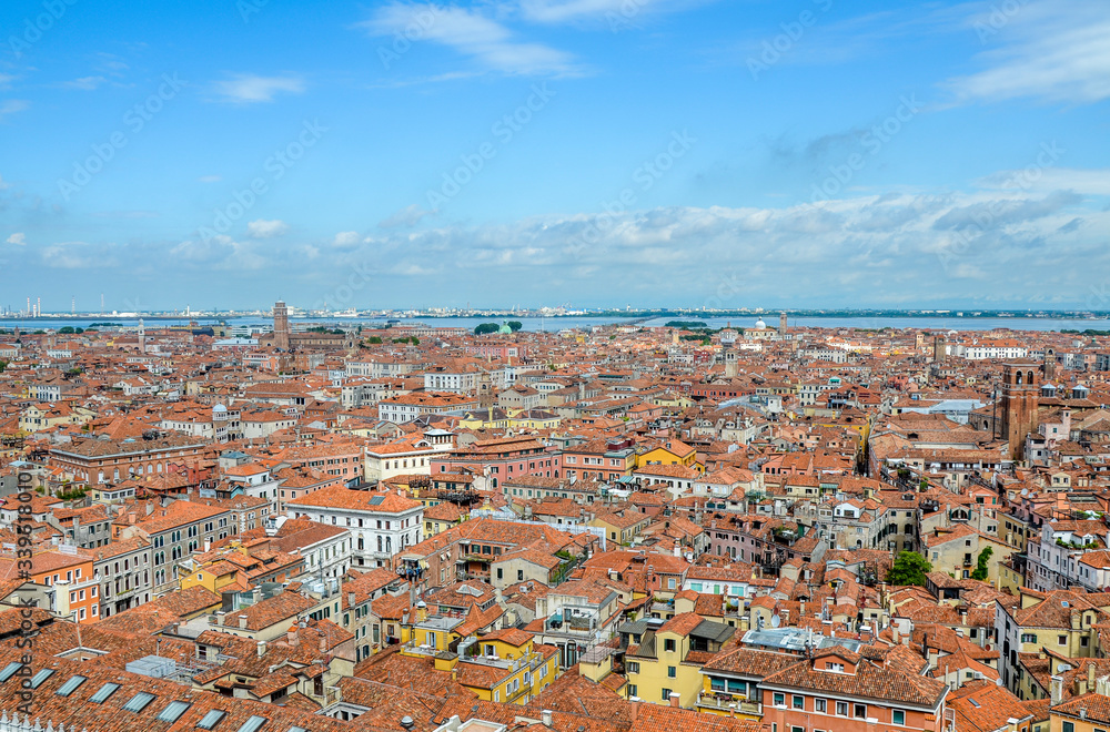 Top view from the top of the Campanile Tower of traditional buildings Venice with red tile roofs. Old European town background. A romantic look Top view from the top of the Campanile Tower of traditional buildings Venice with red tile roofs. Old European town background. A romantic look