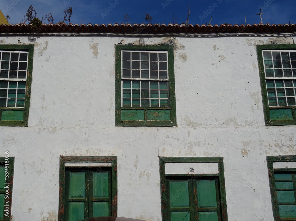 Historic colonial facade with traditional guillotine wood windows in the old city center of Santa Cruz. La Palma Island. Canary Islands. Spain.