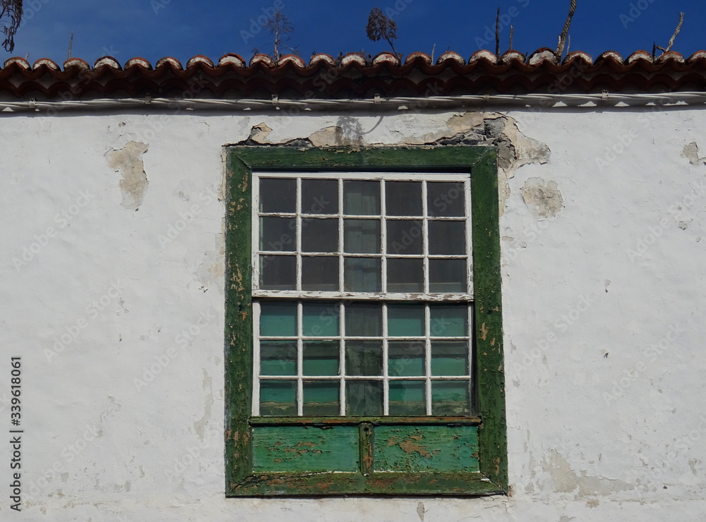 Fototapeta premium Traditional guillotine wood window in historic colonial house. Old city center of Santa Cruz. La Palma Island. Canary Islands. Spain. 