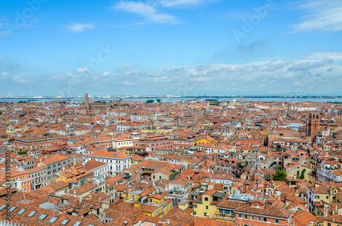 Top view from the top of the Campanile Tower of traditional buildings Venice with red tile roofs. Old European town background. A romantic look