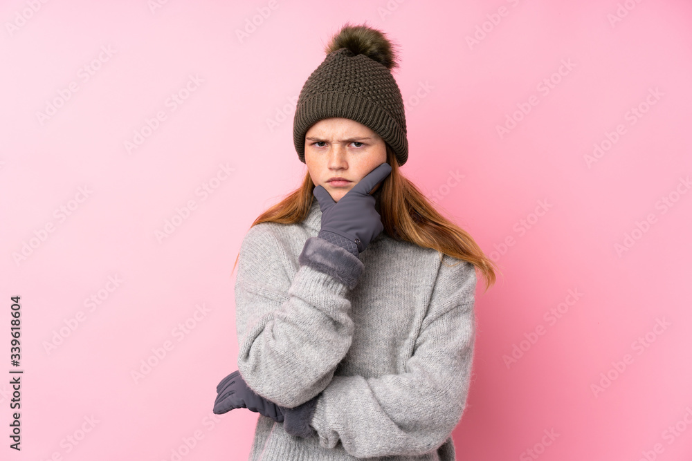 Ukrainian teenager girl with winter hat over isolated pink background thinking an idea Ukrainian teenager girl with winter hat over isolated pink background thinking an idea