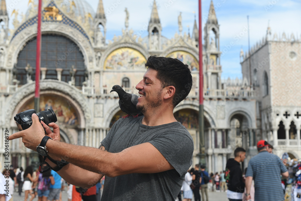 Man taking a selfie with a bird - Venice