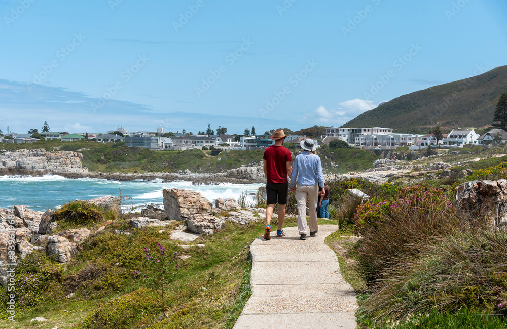 Hermanus, Western Cape, South Africa. 2019. Tourists on the coastal biodiversity walk on the seafront at Hermanus a popular seaside resort on the garden route South Africa
